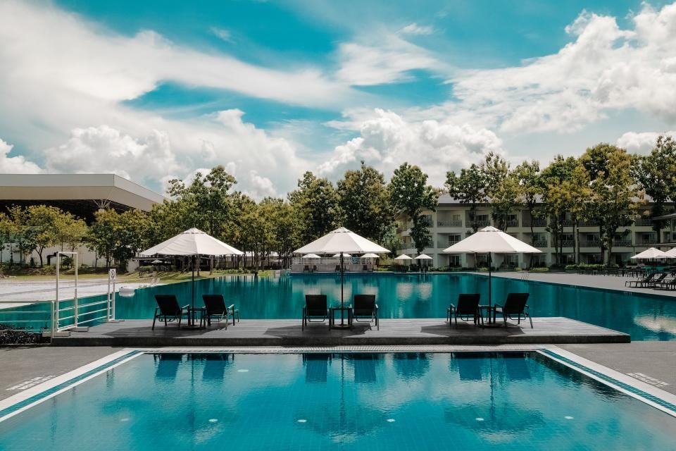 The outdoor swimming pool with loungers alongside