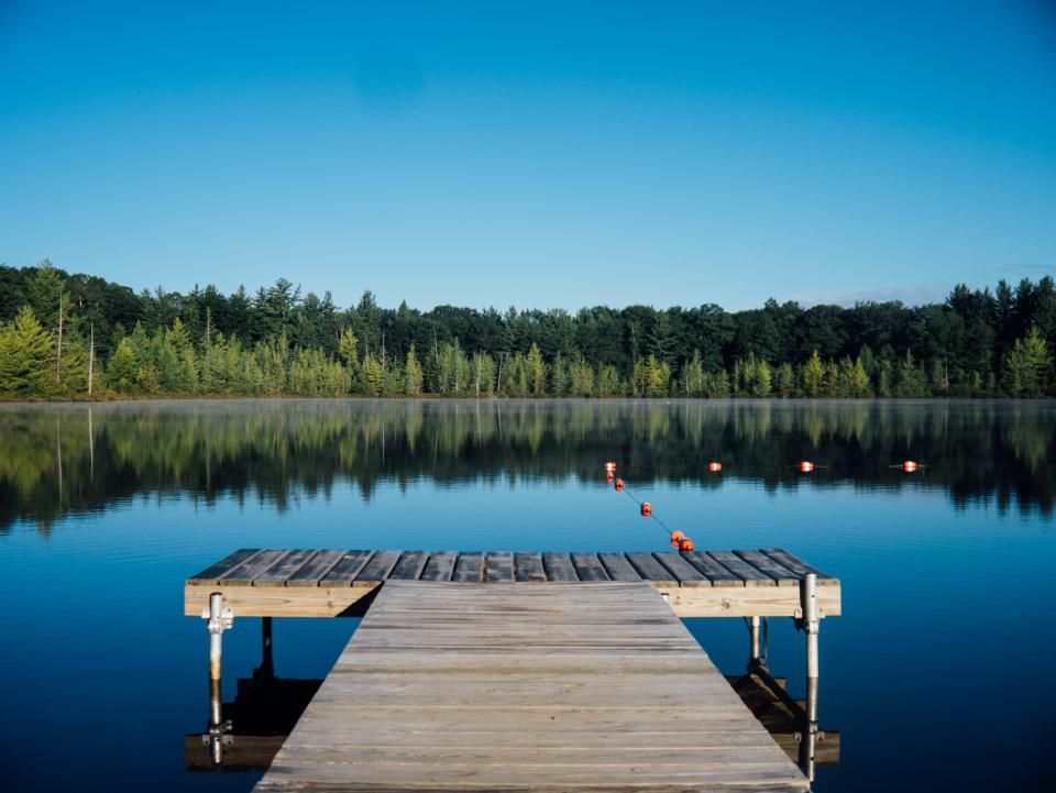 The lake, still, with hills behind